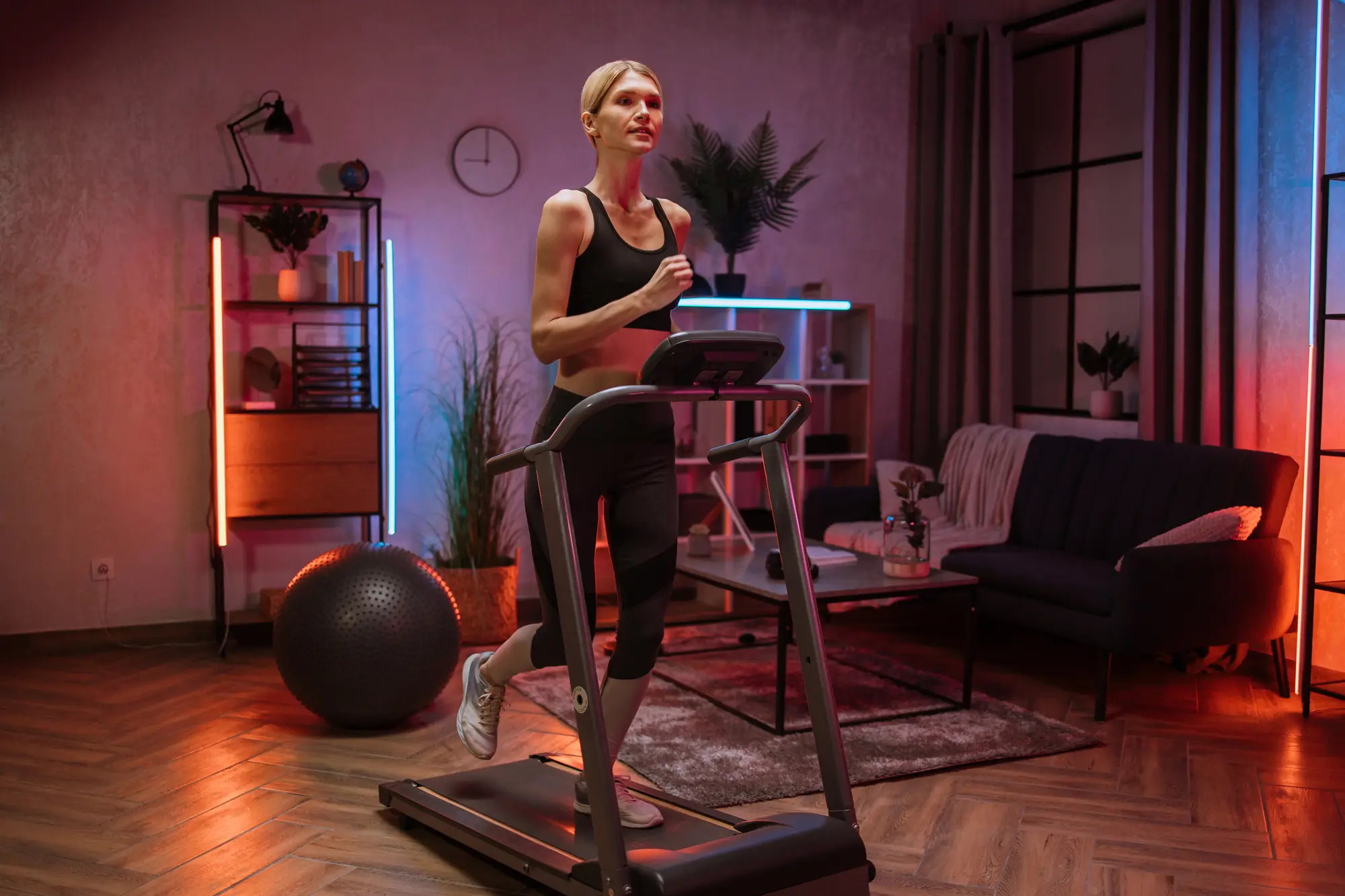 A woman running on a treadmill in her living room